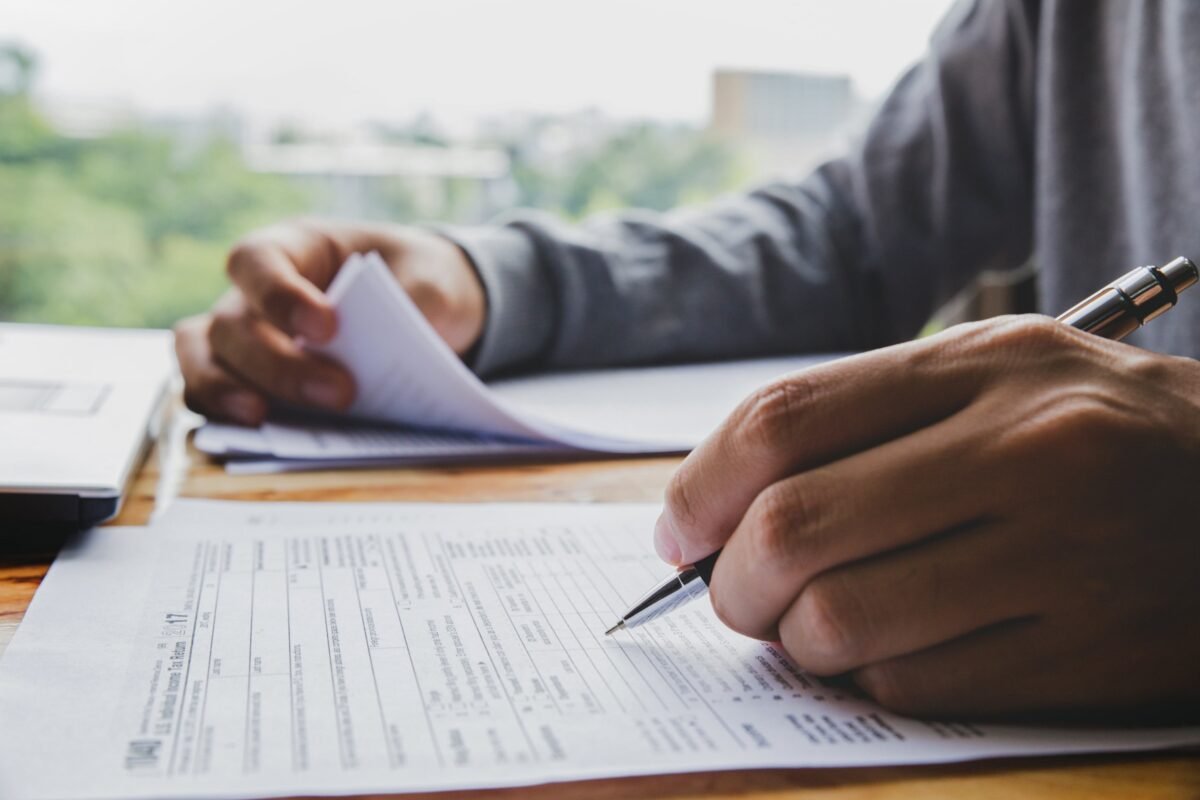 A man filling tax forms for car importing in and near Vancouver, BC, and Blaine, WA